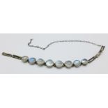 A small white metal and moonstone bracelet,
