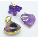 An 18ct gold mounted pendant and two yellow metal mounted amethyst charms