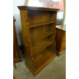 An oak waterfall bookcase with carved tortoise to side