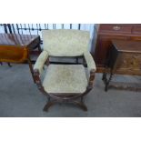 A Victorian mahogany upholstered x-frame open armchair