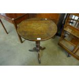 A Victorian oak circular tripod table