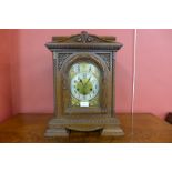 A 19th Century German Junghans carved oak bracket clock