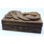 A Chinese carved wooden box with dragon top and carved side,