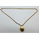 A 9ct gold back and front locket on a rolled gold chain