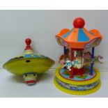 A Red Box toy carousel and a Tri-ang spinning top