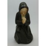 A Royal Worcester Kerr and Binns candle snuffer, kneeling monk,