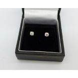 A pair of 18ct white gold and diamond stud earrings, total diamond weight 0.