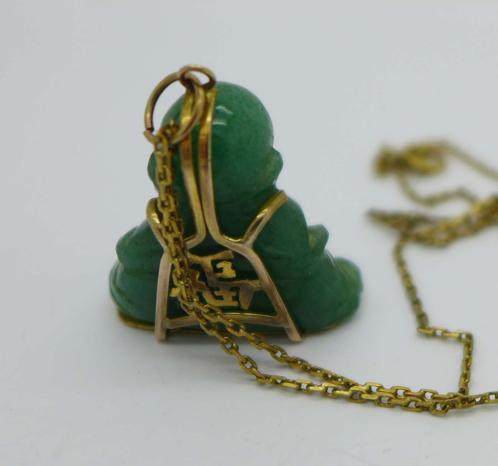 A carved jade Buddha pendant and chain, - Image 2 of 2