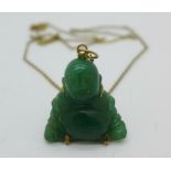 A carved jade Buddha pendant and chain,