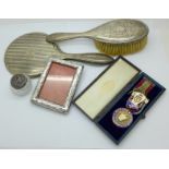 A silver lodge medal, a silver backed brush and mirror,