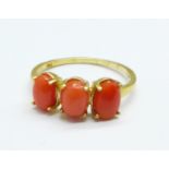 A silver gilt coral trilogy ring,