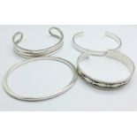 Four silver bangles,