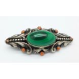 A silver Arts & Crafts malachite and coral brooch by Austro-Hungarian designer Zoltan White,