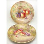 A pair of Orb cabinet plates, hand decorated with fruit, signed Frank Higgins,