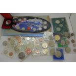 A collection of foreign coins; ten sets and five single coins in cases,