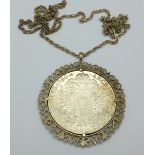 A Marie Theresia coin, mounted and with a silver chain,