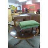 A circular inlaid mahogany dining table,