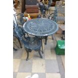 A cast aluminium garden table and two chairs