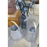 A pair of stainless steel milk churns and a painted metal coal scuttle