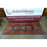 A red ground runner rug,