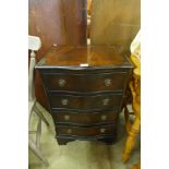 A small mahogany serpentine chest of drawers