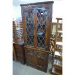 An oak freestanding corner cabinet