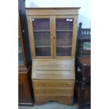 An oak bureau bookcase