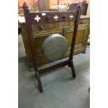 An Arts and Crafts oak and bronze gong,