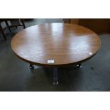 A teak circular coffee table on chrome stand