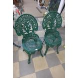 Two cast metal garden chairs