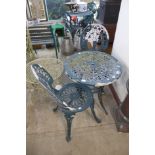 A cast metal table and two chairs