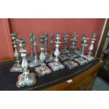 Seventeen silver plated candlesticks (some lacking sconces)