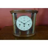 A Sewills walnut and glass four sided mantel clock