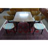A G-Plan Librenza tola wood drop-leaf table and four butterfly back chairs