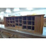 A Victorian mahogany tambour front pigeon hole cabinet