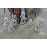 A set of five concrete cricket garden figures