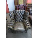 A chestnut leather Chesterfield wingback armchair