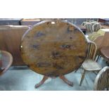 A Victorian pine circular tilt top breakfast table