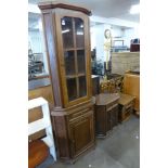 Two oak corner cabinets and an oak magazine rack