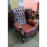 A red leather Chesterfield wingback armchair