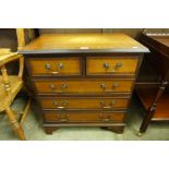 An inlaid mahogany chest of drawers