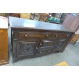 A Victorian carved oak sideboard