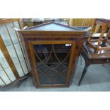 A George III inlaid mahogany hanging corner cabinet