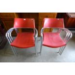 A set of six red and chrome stacking chairs