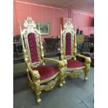 A pair of large gilt Lion King Throne chairs