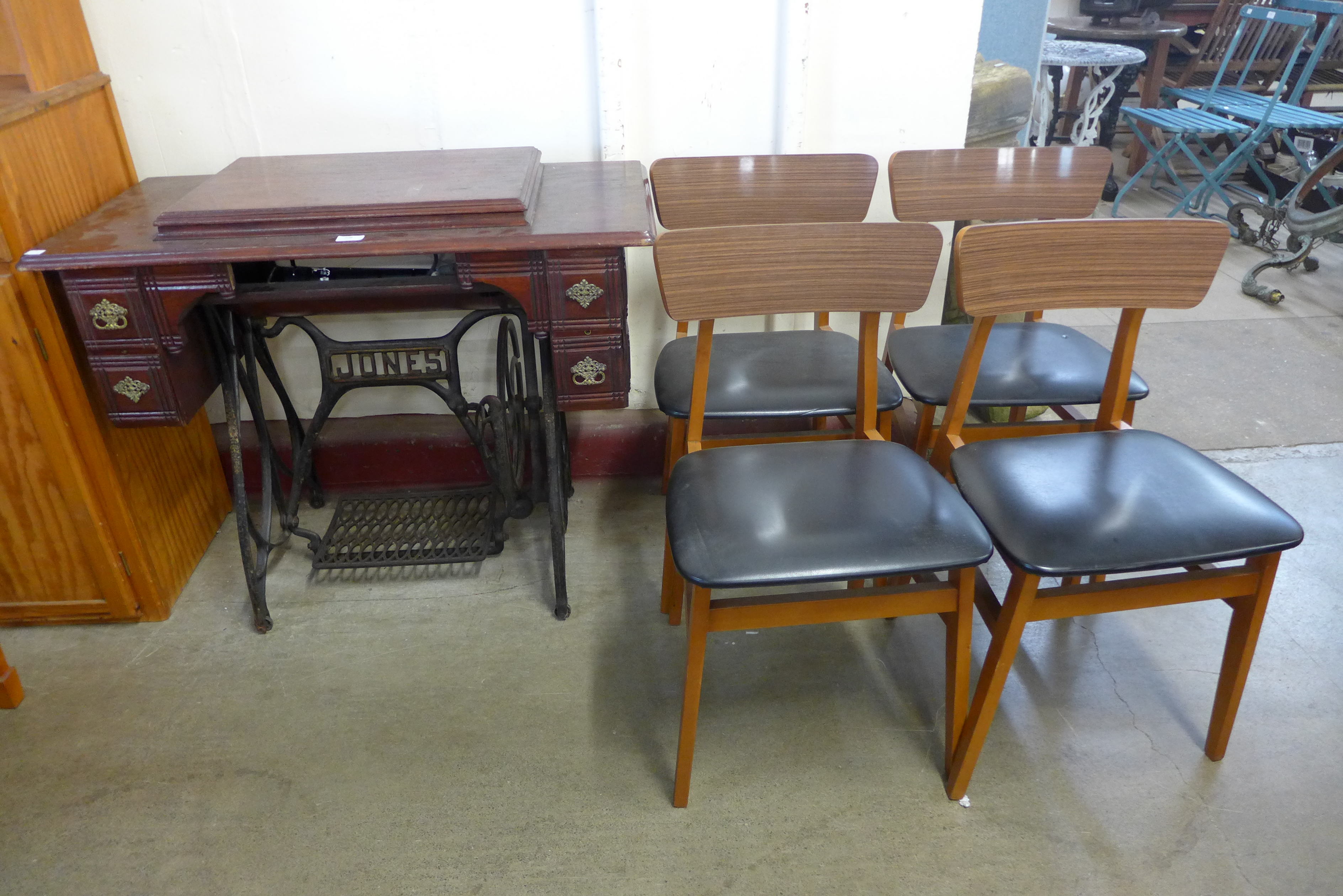 A treadle sewing machine and a set of four chairs