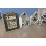 Two cream and parcel gilt dressing table mirrors and a gilt cherub mirror