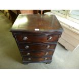 A small mahogany serpentine chest of drawers