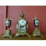A German Franz Hermle porcelain and gilt metal clock garniture,