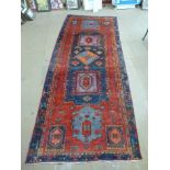 A red ground runner rug,